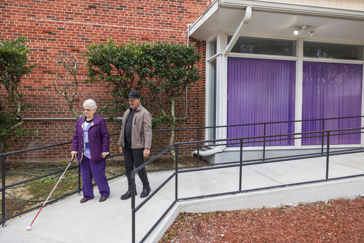 Orientation and mobility specialist assisting a client.